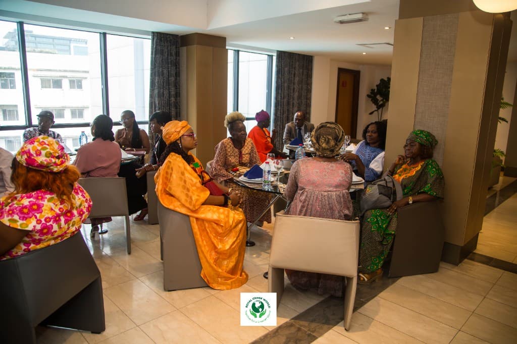Delegates in conversation around tables in the hotel lounge